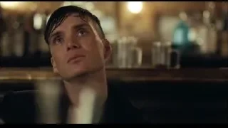 young man smoking at dimly lit bar — Peaky Blinders