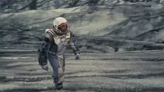 man in space suit with gun — Interstellar
