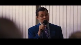 man in blue suit speaking into microphone — The Wolf Of Wall Street