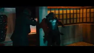 man aiming gun in dimly lit room — John Wick: Chapter 4