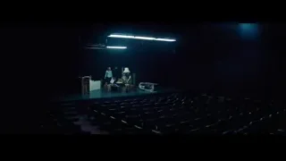 person at podium on stage in auditorium — La La Land
