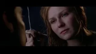 Young woman holding needle with serious expression — Spider Man 2