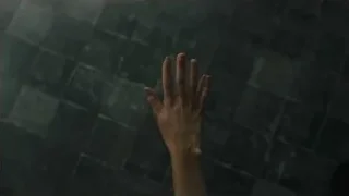 person's hand reaching up from tiled floor — Blade Runner 2049