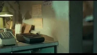 man holding telephone in dimly lit room — Joker