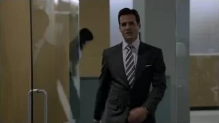man in suit walking in office lobby — Suits