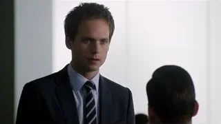 Man in suit standing with serious expression — Suits