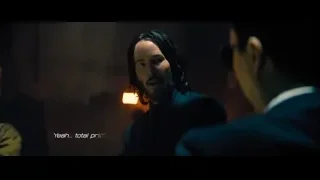 Two men in dim room having serious conversation — John Wick: Chapter 4