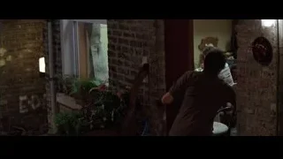 man by window with potted plants — Batman