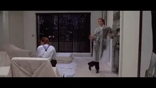 woman sitting on white couch by window — American Psycho