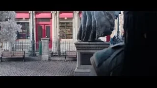 Man in red cape with sword by dragon statue — Doctor Strange 2