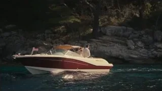 Red speedboat near rocky cliff — Succession