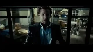 man in suit looking into storage room — Limitless