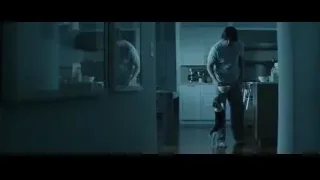 Man holding knife in kitchen with dog — John Wick