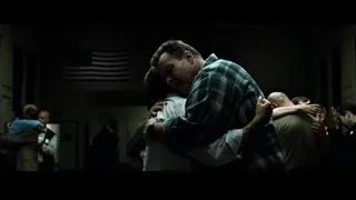 People hugging distressed man in room with American flag — Fight Club