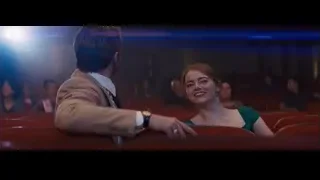 man and woman sitting in movie theater — La La Land
