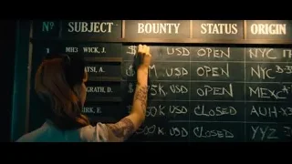 woman pointing at blackboard with notes — John Wick: Chapter 4