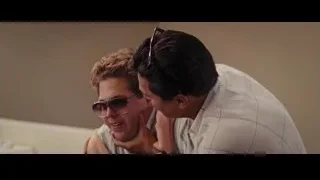 Two men conversing on living room couch — The Wolf Of Wall Street