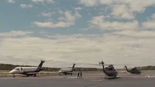 Military helicopters and private jet on tarmac — Succession