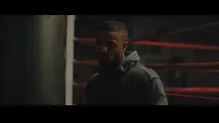 man deep in thought in boxing ring — Creed 2