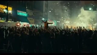 man performing on stage at night — Joker