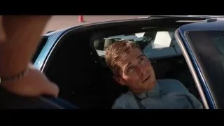 man sitting in a blue car — Ford v Ferrari