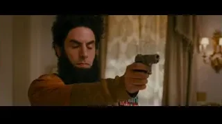 bearded man pointing gun in room — The Dictator