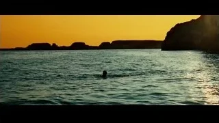 person swimming in ocean at sunset — Limitless