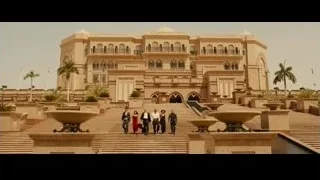 People walking up stairs to luxurious building — Furious Seven