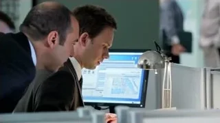 man in suit looking at map on computer — Suits