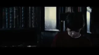 Ron Weasley standing in dimly lit library — Harry Potter and the Philosophers Stone
