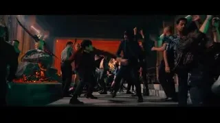 People dancing on stage with red and green lights — John Wick: Chapter 4