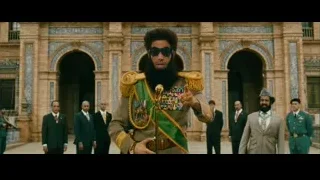 Man in military uniform with sword by ornate building — The Dictator
