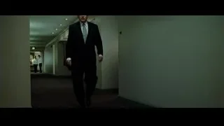 man in a suit walking down a long hallway — Fight Club
