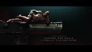 Man in red suit lying on large gun — Deadpool 2