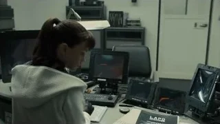 woman at desk with multiple computer monitors — Blade Runner 2049
