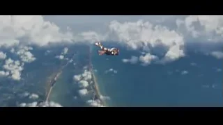 Person skydiving over land and water — Iron Man 3