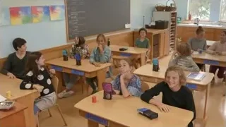 Children sitting at desks in classroom — Screened Out