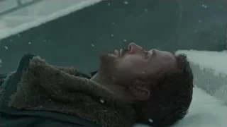 Man lying in falling snow — Blade Runner 2049