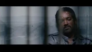 man with beard sitting behind bars — The Persuit of Happyness