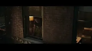 Young man looking out window in dim room — Spiderman: No Way Home