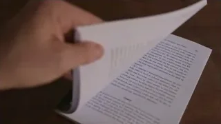 hand holding open book with text — Screened Out