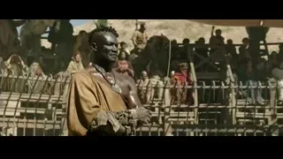 man speaking to crowd in desert — Gladiator 2