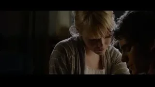 Young couple sitting in dimly lit room — The Amazing Spider Man