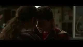 young couple embracing in dimly lit room — Spiderman: No Way Home