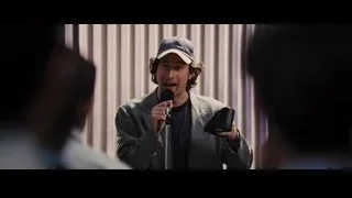 Man in baseball cap speaking into microphone — The Wolf Of Wall Street
