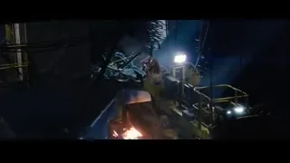 Crane lifting metal into water at construction site — Iron Man 3
