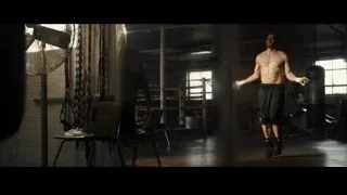 Shirtless man running in a dimly lit gym — Southpaw