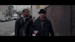 Two men conversing on a street corner — Creed
