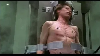 Man connected to medical device in dark room — Spider Man