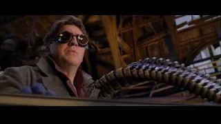 Man in sunglasses holding metal object in workshop — Spider Man 2